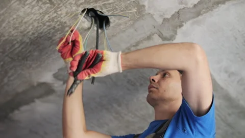 Electrician installing and connecting ceiling wiring Stock Footage 320785909