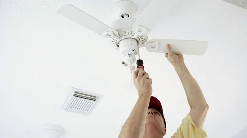 Electrician installing the blades to the ceiling fan 4k Stock Footage 73399710