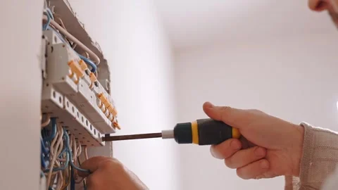 Electrician Installing Circuit Breakers in Electrical Panel Stock Footage 348061506