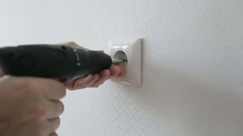 Electrician installing  current socket with power drill. Stock Footage 71777762