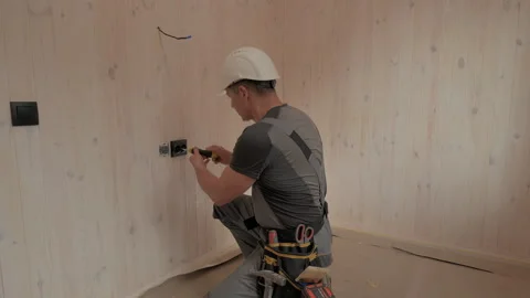 Electrician Installing Electrical Outlet in New Home Construction Stock Footage 278748293