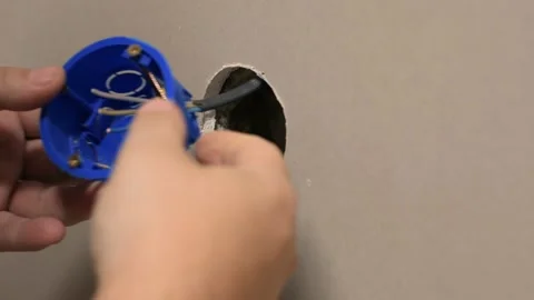 Electrician installing electrical outlet on the wall Stock Footage 142698041
