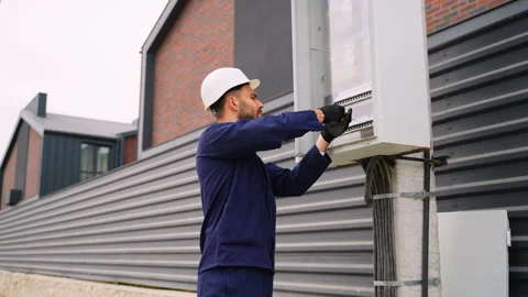 Electrician installing electrical panel in cottage community Stock Footage 300897807