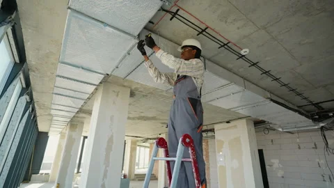 Electrician installing electrical wiring on ceiling Stock Footage 312837531