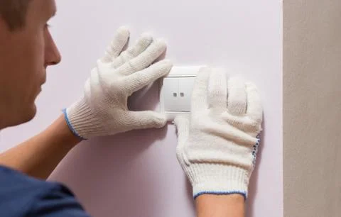 Electrician installing light switch, close up photo Stock Photos