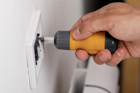 Electrician installing light switch 写真素材