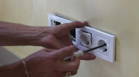 Electrician installing new current socket with screwdriver Stock Footage 68441674