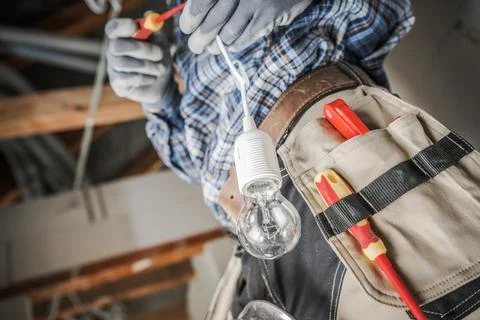 Electrician Installing New Light Point Inside a House Foto stock