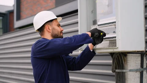 Electrician installing outdoor electrical panel wiring Stock Footage 300894103