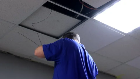 Electrician Installing Overhead Wiring Under Ceiling Stock Footage 295490757