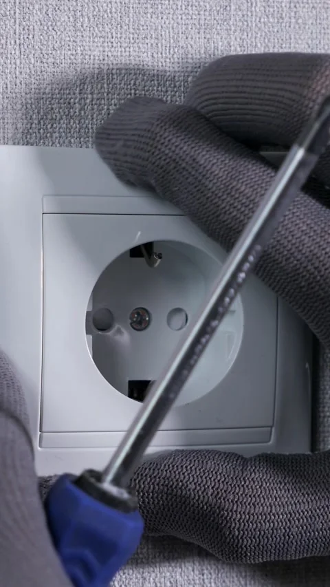 Electrician installing a schuko wall socket with a screwdriver, close up view 库存影片 342904402