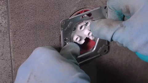 Electrician installing wall socket in concrete wall Stock Footage 304117200