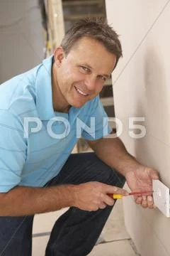 Electrician Installing Wall Socket Stock Photos