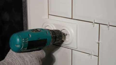 Electrician installs a double socket in the kitchen with a screwdriver. Stock Footage 139033071
