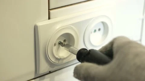 Electrician installs a double socket in the kitchen with a screwdriver. Stock Footage 139921512