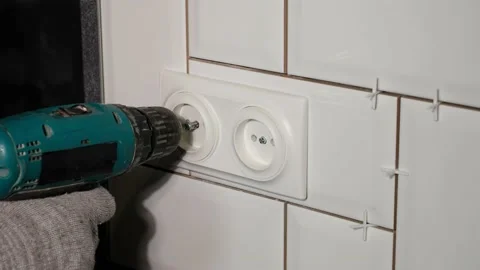 Electrician installs a double socket in the kitchen with a screwdriver. Stock Footage 140936988