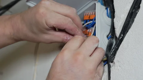 An electrician installs a junction box. Stock Footage 150312254