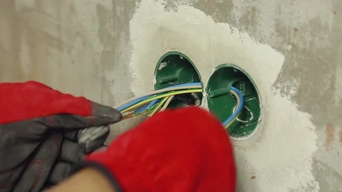 Electrician lays wires in socket Stock Footage 150351878