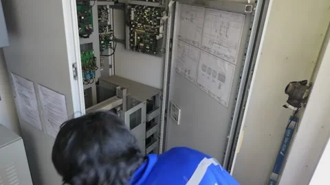 Electrician Maintenance on an Electrical Cabinet Panel Stock Footage 222283860