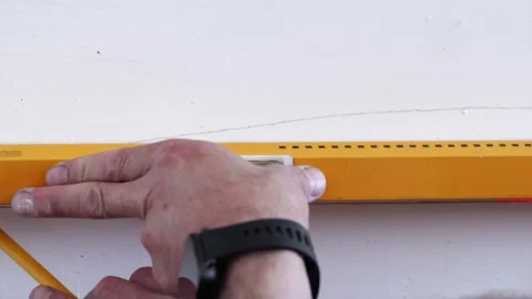 Electrician marking concrete wall for cable conduit channeling Stock Footage 339298323