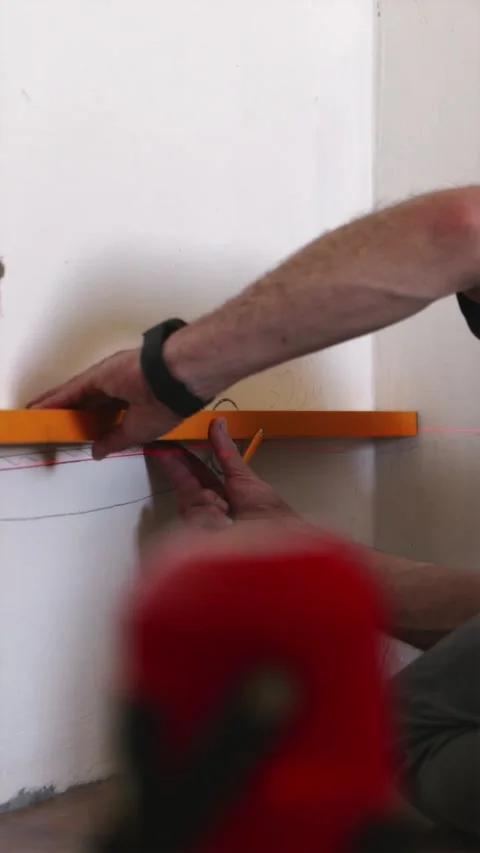Electrician marking wall for cable conduit channeling vertical Stock Footage 339298256