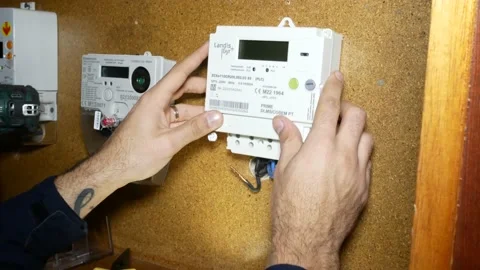 Electrician Mount a Digital Smart Meter Electric Stock Footage 232060478