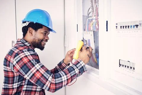 Electrician multimeter, electric switch box and happy man check cable current Stock Photos