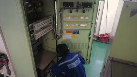 Electrician Opening Cabinet Panel for Maintenance Stock Footage 222283779
