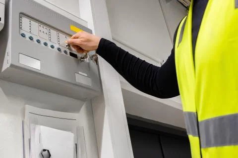 Electrician Opening Fire Panel In Server Room Foto stock