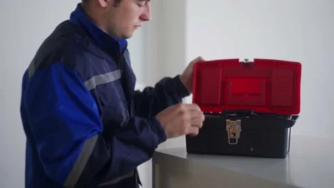 Electrician opens a toolbox, takes screwdriver to fix electricity and repair Stock Footage 182522934