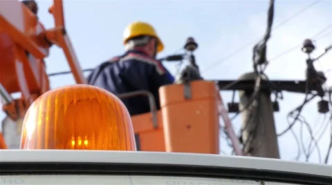 Electrician performing intervention on electric pole, rotating beacon, low angle Stock Footage 55879681