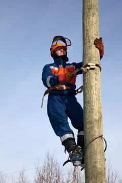 Electrician on a pole Stock Photos