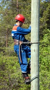 Electrician on a pole Stock Photos