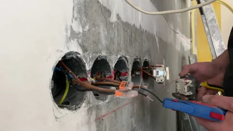 The electrician prepares with wire stripper plier prepares  electricial wires Video stock 153802787