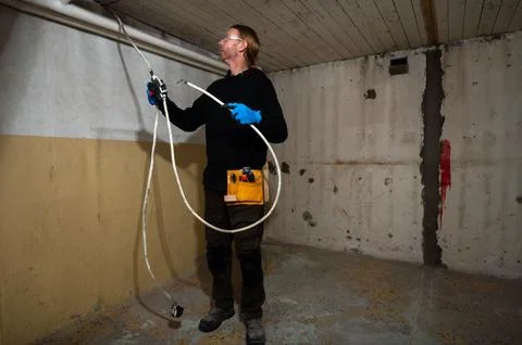 Electrician preparing electrical cable at ceiling junction box Stock Photos
