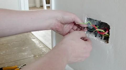 Electrician: preparing the wires for a UK plug wall socket Stock Footage 45193158
