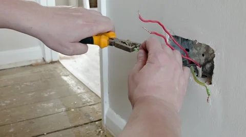 Electrician: preparing the wires for a UK plug wall socket Stock Footage 45193431