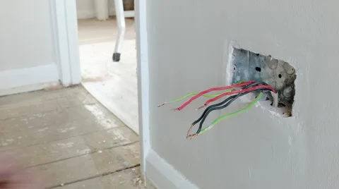 Electrician: preparing the wires for a UK plug wall socket Stock Footage 45193910