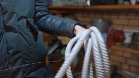 Electrician pulling wire through corrugated electrical conduit pipe Stock Footage 327667977