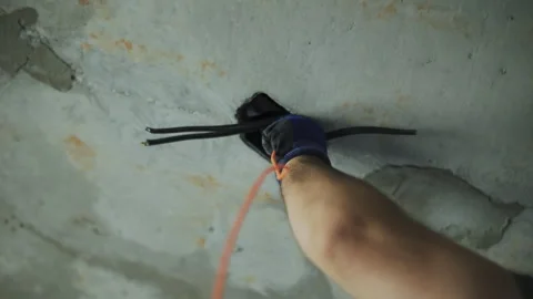 Electrician pulling wires in an apartment at a construction site Stock Footage 287643027