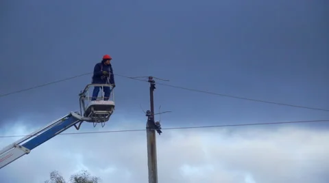Electrician removes the wire from the post Stock Footage 58197111