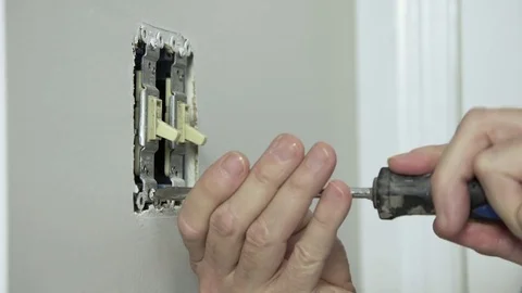 Electrician removing an old toggle wall switch 4k Stock Footage 73401845