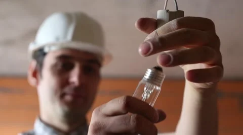 The electrician screw the light bulb Stock Footage 61651613