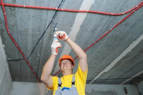 The electrician is setting a bulb. Stock Photos