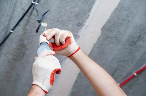 An electrician is setting a bulb. Stock Photos