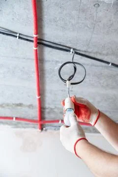 An electrician is setting a bulb. Stock Photos