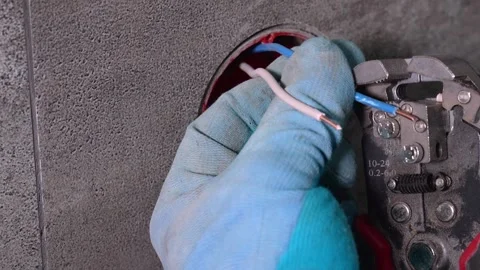 Electrician stripping electrical wire with wire strippers Stock Footage 304117126