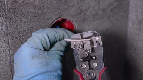 Electrician stripping electrical wire with wire strippers Stock Footage 304119715
