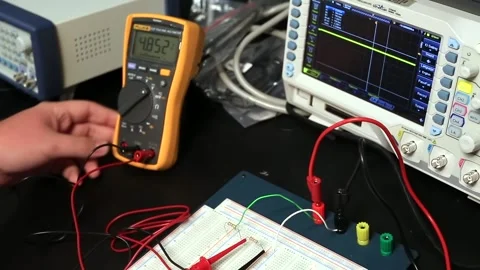 Electrician student checking voltage and amps with multimeter Stock Footage 161498488
