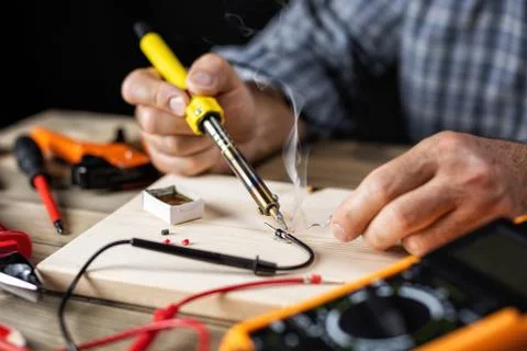 Electrician technician at work. Electronics. Stock Photos
